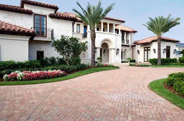 Luxury Mediterranean-style estate with brick driveway